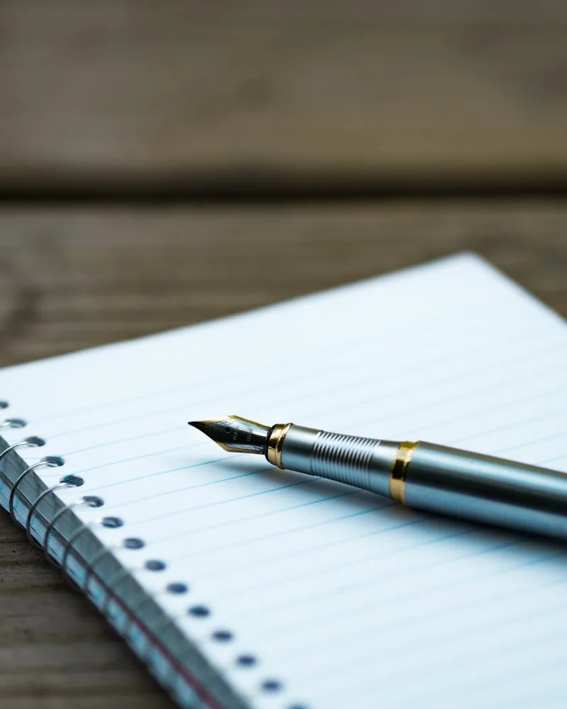 Editor's notebook and fountain pen on the desk