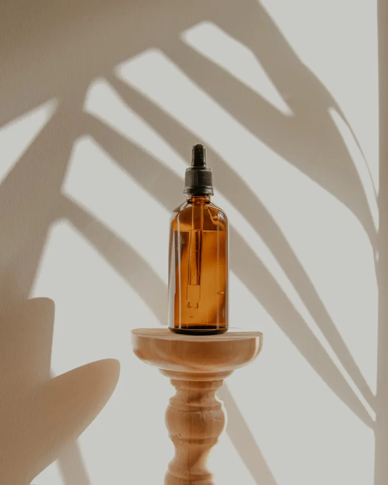 Dropper bottle on a turned plinth in low sun