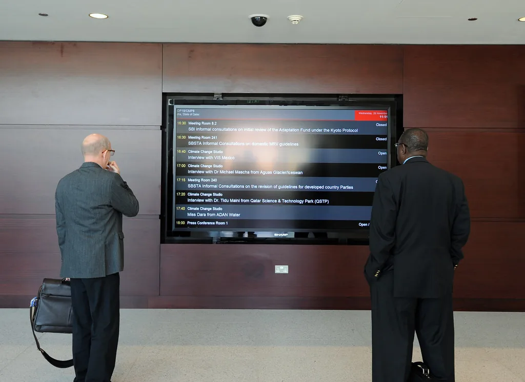 two people reading a wall display